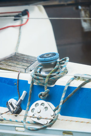 winch and nautical ropes on a sailing boat in the port