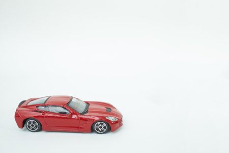 Many multi-colored toy cars on white background. The group of car toy. Small cars on white table, top view with copy space.の写真素材