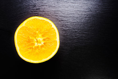 Orange fruit isolated on black backgroundの写真素材