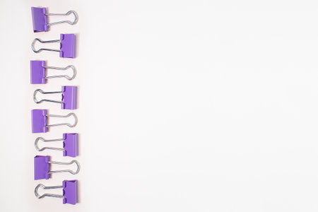 Purple paper clips on a white background close up. Textureの写真素材