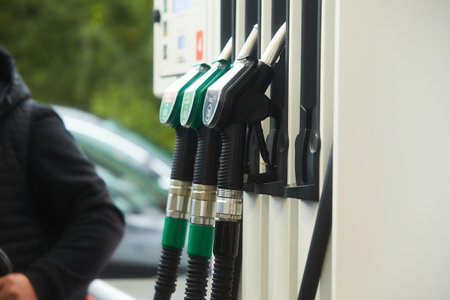 A man refueling a car at a petrol station