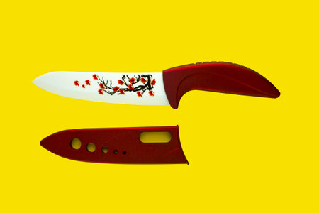 Red knife ceramic on a yellow background.の写真素材