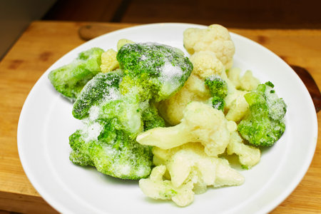 A plate with frozen broccoli in the kitchen table.の写真素材