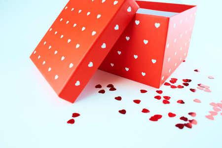 Red gift box with hearts pattern isolated on white background.の写真素材
