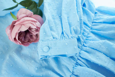 Blue cloth with vintage rose. Vintage background with blooming flower.