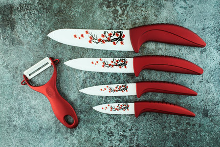 Red knife ceramic on a grunge cement texture background.の写真素材