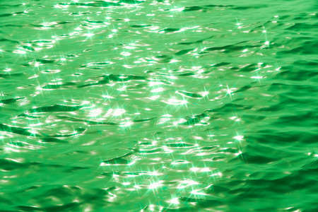 Detail of a sunlight reflecting in glittering sea. sparkler in water - background. sea water with sun glare and ripple. Powerful and peaceful nature concept.の写真素材