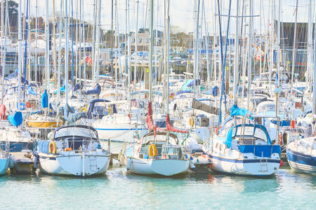 Boats in harbor with blue colorful cloudy sky in background.のeditorial素材