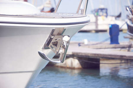 Yacht anchor close-up seen on the front of a luxury boat. Sailboat bow parked in harbor, yachting, sailingの写真素材