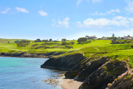 High cliff on tropical beach. Tropical nature. Beautiful blue sea water and green tropics of...