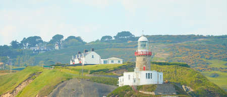 A look on famous landmark lighthouse and Dublin bay on a cloudy sunny day from Howth Head Summit.の写真素材