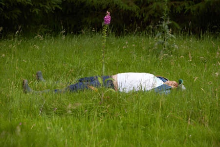 A caucasian disability man resting in the bright green fresh forest.の写真素材
