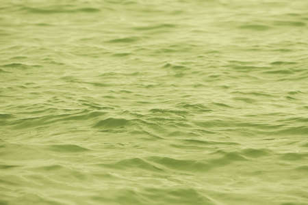 Detail of a sunlight reflecting in glittering sea. sparkler in water - background. sea water with sun glare and ripple. Powerful and peaceful nature concept.の写真素材