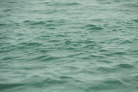 Detail of a sunlight reflecting in glittering sea. sparkler in water - background. sea water with...