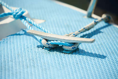 Mooring rope and bollard on sea water and yachts backgroundの写真素材