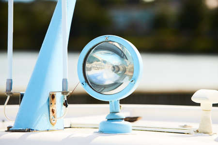 Flood light on the roof of a boat. Navigation light for travelling at night and the correct mooring. Ship's searchlight.の写真素材