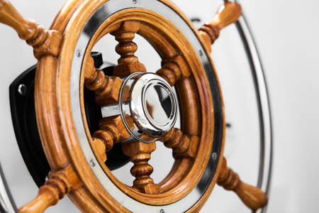 Close up of steering wheel made of wood on a boat.の写真素材