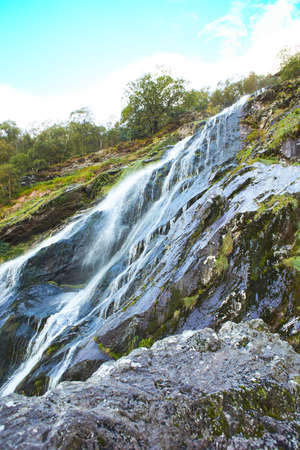 Majestic water cascade of Powerscourt Waterfall, the highest waterfall in Ireland. Famous tourist...