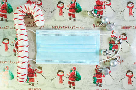 Face mask and festive decorations on the New Year background. Corona virus Christmas background....