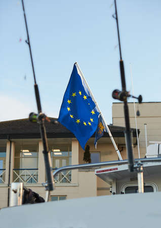 Fishing rods with European flag on the boat in natural setting