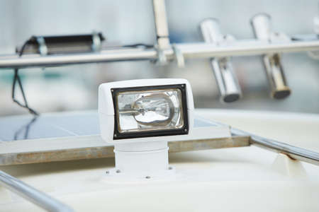 Flood light on the roof of a boat. Navigation light for travelling at night and the correct mooring. Ship's searchlight.の写真素材