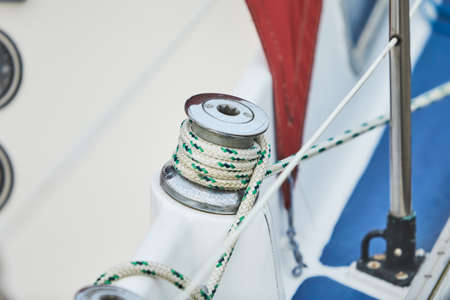 Winch and nautical ropes on a sailing boat in the portの写真素材