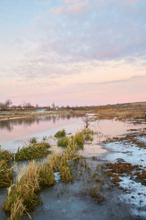 Beautiful natural landscape with birch and frozen river in winter.の写真素材