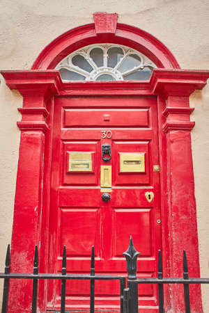 View of brightly coloured traditional English house door.の写真素材