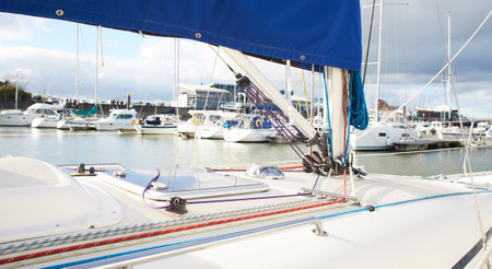 Winch and nautical ropes on a sailing boat in the port