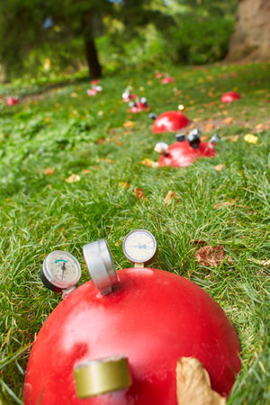 Many air pressure gauges in the compressor receiver in the green grass