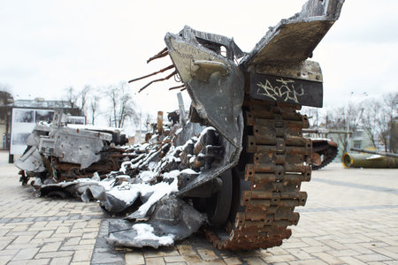 Kyiv, Ukraine - 03.29.2023: Civilian car shot by Russian soldiers. War in Ukraine. Destroyed russian tank on the Mykhailivs'ka Square.のeditorial素材