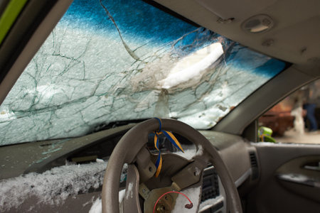 Kyiv, Ukraine - 03.29.2023: Civilian car shot by Russian soldiers. War in Ukraine. Destroyed russian tank on the Mykhailivs'ka Square.のeditorial素材