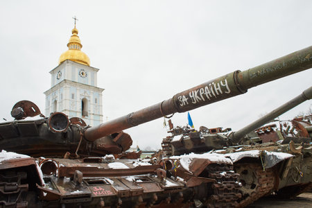Kyiv, Ukraine - 03.29.2023: Civilian car shot by Russian soldiers. War in Ukraine. Destroyed russian tank on the Mykhailivs'ka Square.のeditorial素材