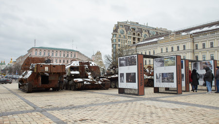Civilian car shot by Russian soldiers. War in Ukraine. Destroyed russian tank on the Mykhailivs'ka Square.のeditorial素材