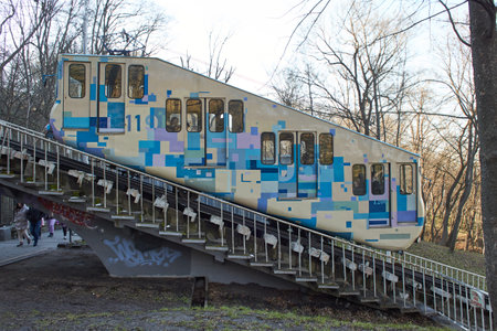 Kyiv, Ucraine-03.30.2023: A blue and white cable funicular rises on rails along the slope. Funicular tram, side view. Station Kyiv, Ukraineの写真素材