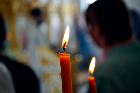 Picture of a Burning candles in orthodox church.Praying people.の写真素材