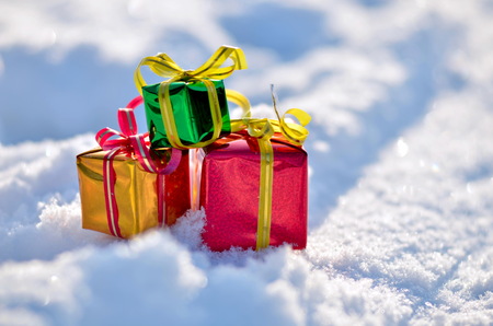 Christmas gifts in the snow. Winter season background.の写真素材