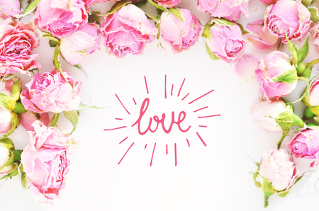 Love. Flowers composition. Frame made of dried rose flowers on white  background.の写真素材