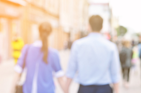 Blurred image of young couple walking on the street.の写真素材