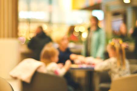 Blurred background. Blurred silhouettes of sitting people in coffeeの写真素材