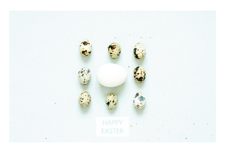 Inscription Happy Easter. Pattern with quail eggs and  feathering on blue background.