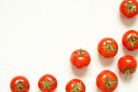 Raw tomatoes on a light concrete background.Top view with copy space. - Imageの写真素材