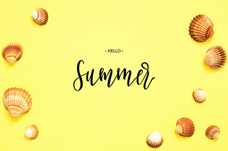 Inscription Hello Summer. Sea shells pattern on yellow paper background. Summer concept. Flat lay,...
