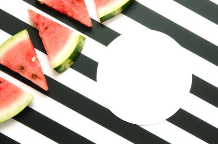 Fresh red watermelon slice on striped background. Summer concept. Top view, Flat lay. Copy space. -...