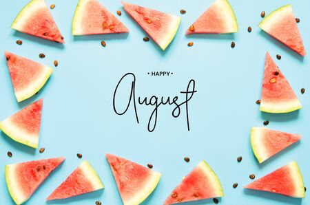 Inscription Happy August. Fresh red watermelon slice Isolated light blue background. Top view, Flat lay. - Imageの写真素材