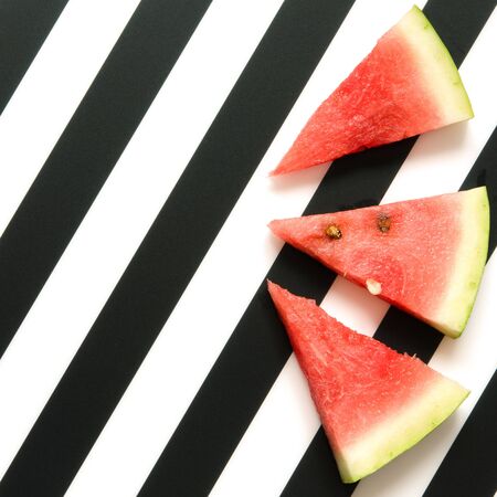Fresh red watermelon slice on striped background. Summer concept. Top view, Flat lay. - Imageの写真素材