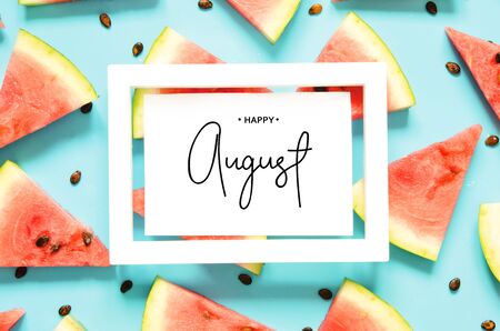 Inscription Happy August. Fresh red watermelon slice Isolated light blue background. Top view, Flat lay. - Imageの写真素材