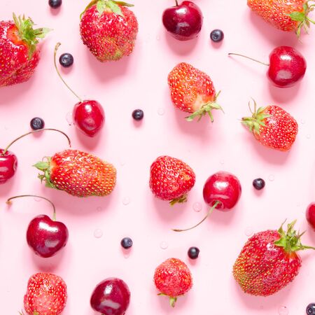 Strawberry, cherry and blueberry on pink background. Flat lay, top view. - Imageの写真素材