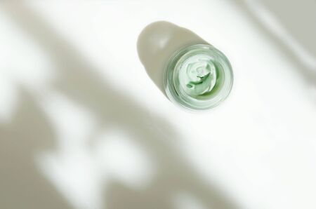 Facial cream on white background. Skin care concept. Natural hard light, deep shadows. - Imageの写真素材