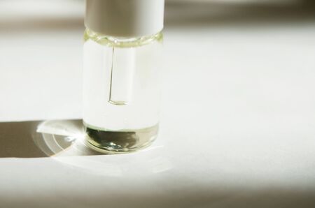 Cosmetic or medical glass bottle with pipette on white background. Skin care concept. Natural hard...